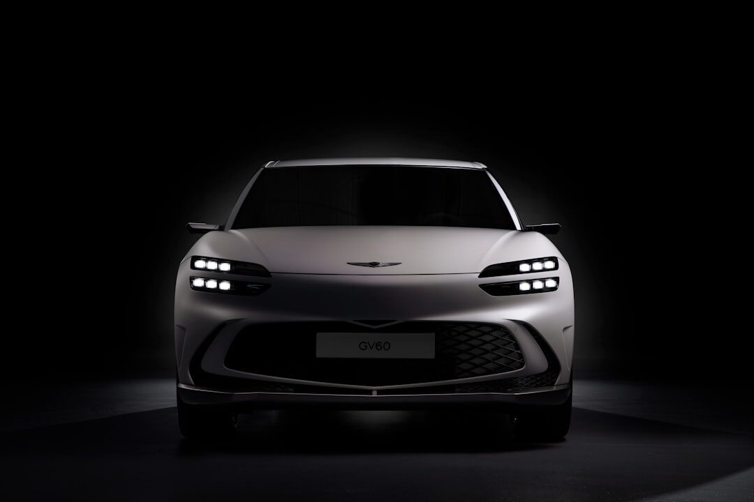 Modern hypercar photographed in a dark studio with dramatic lighting