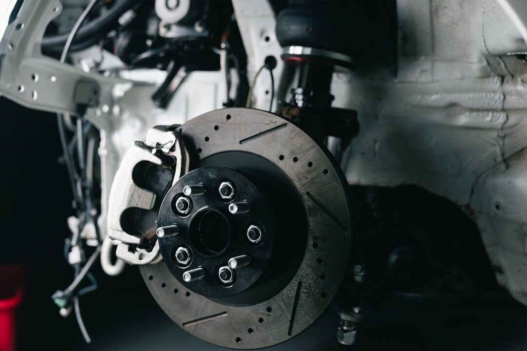 person inspecting car brakes