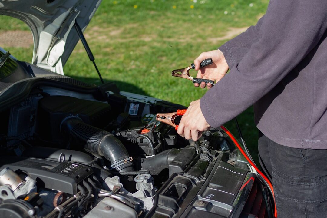 mechanic checking car engine